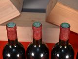 several bottles of wine are lined up in a row on a table