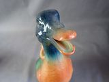 a colorful duck figurine sitting on top of a table