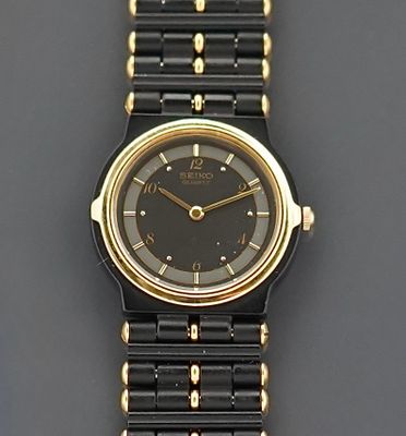 Seiko Montre de dame en métal noir et plaqué or, boitier ron…