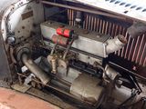 an old engine in the back of an old car
