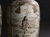 two vases that are sitting side by side on a black background