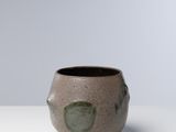 bowl with green glazes on a white surface
