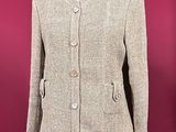 a beige tweed jacket on a mannequin mannequin mannequin mannequin mannequin mannequin mannequin mannequin manne