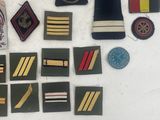 some of the badges are laid out on a white surface