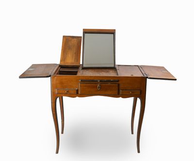 a small wooden table with a mirror on top of it