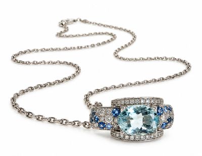 a blue topaz and white topaz necklace on a chain