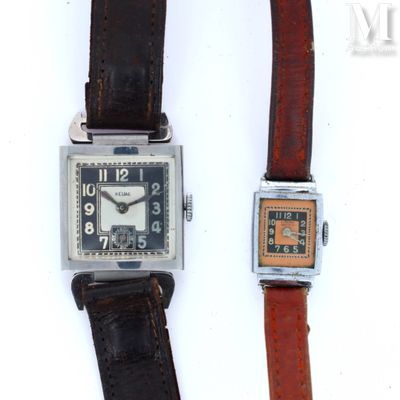 two watches sitting next to each other on a white surface