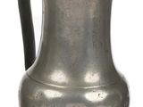 an old silver pitcher with a handle on a white background