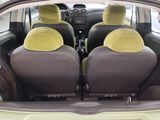 four seats in the back of a car with a yellow seat cover