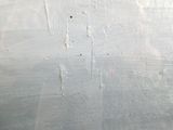 a close up of a piece of white paint on a wall