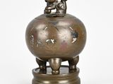 a small bronze statue of a boy and a girl on a globe