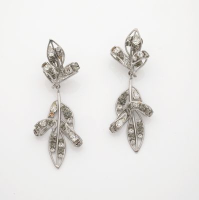 a pair of diamond and silver earrings