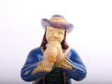 a figurine of a man wearing a hat and holding a pipe