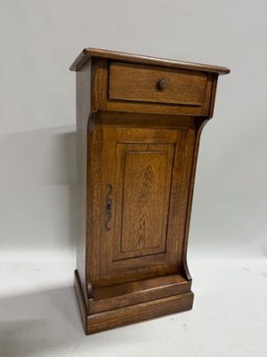 an old wooden cabinet with a drawer on top of it