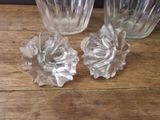 two glass vases sitting on a table next to each other