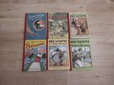 four children ' s books are lined up on a wooden floor