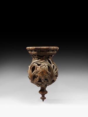 an image of a wooden vase with a face on it