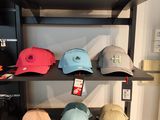 many hats that are on a shelf in a room