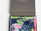 the box is open to show the contents of a tie and handkerchief