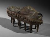 an old wooden foot stool sitting on top of a white surface