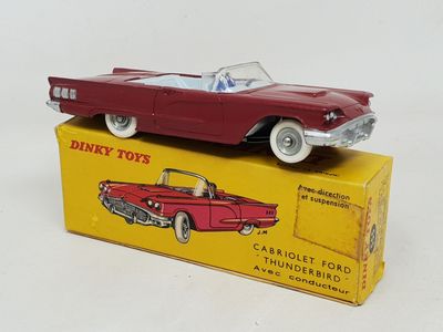 a red toy car sitting on top of a yellow box