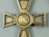 a gold cross with a lion on it and a ribbon around it