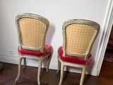 two chairs sitting next to each other on a hard wood floor