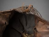 a brown hat with a bird on it sitting on a table