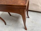 a small table with a wooden top on a concrete floor