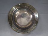 a silver plate on a table with a white table cloth