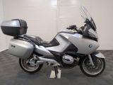 bmw motorcycle parked in a garage with a black and white checkered floor