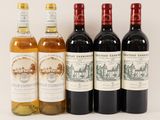 four bottles of wine sit next to each other on a white surface
