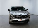 the front view of a silver car parked in a white room