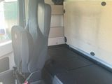 a seat in the back of a van with a laptop on it