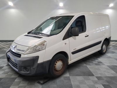 the white van is parked in a large room with a checkered floor