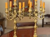 candles are lit on a table in a formal dining room