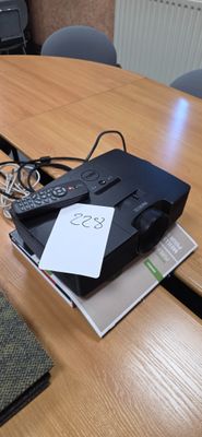 une télécommande posée sur une table à côté d'un ordinateur portable