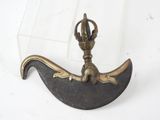 a small metal object with a crown on top of it