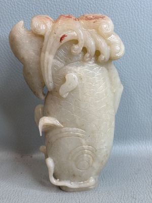 a white vase with a dragon on it sitting on a table