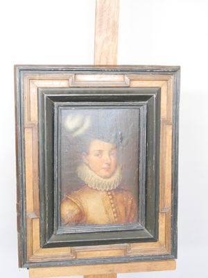 painting of a woman in a yellow dress is on a easel