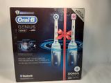 a box of toothbrushes with a red ribbon on it