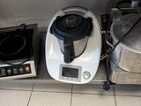 two pots and a blender sitting on a counter