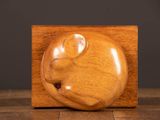 a close up of a wooden sculpture of a mouse on a table