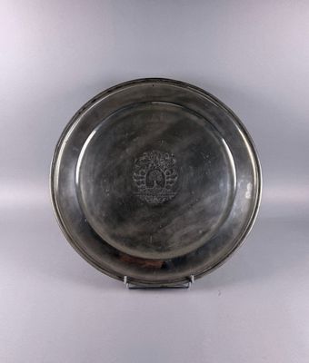 an antique silver plate with a floral design on the rim