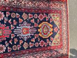 rug on the ground with a shadow of a person standing next to it