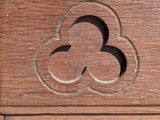 a close up of a wooden cabinet with a flower carved into it