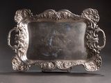 an antique silver plate with a picture of a woman in a dress