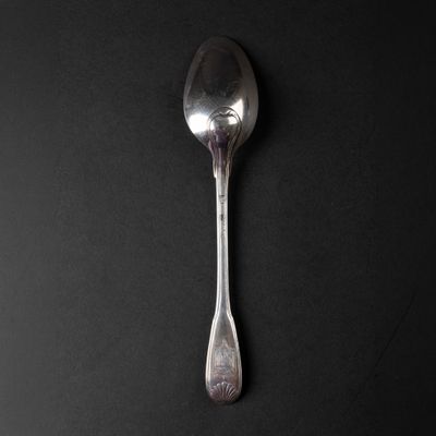 a spoon that is sitting on a black surface
