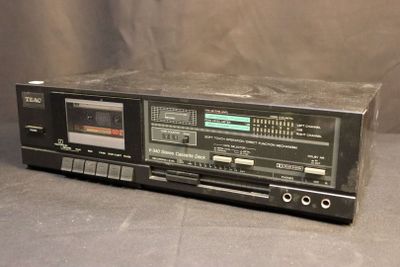 an old stereo player sitting on top of a table next to a wall
