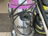 two vacuums and a canister on the floor